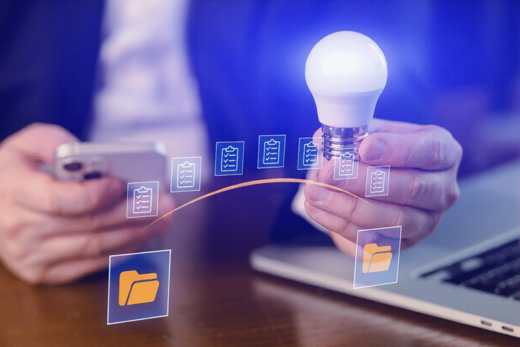 Business Person Holds Light Bulb While Using Smartphone Laptop With Document Icons 175356 23904 Ezremove 1024x683